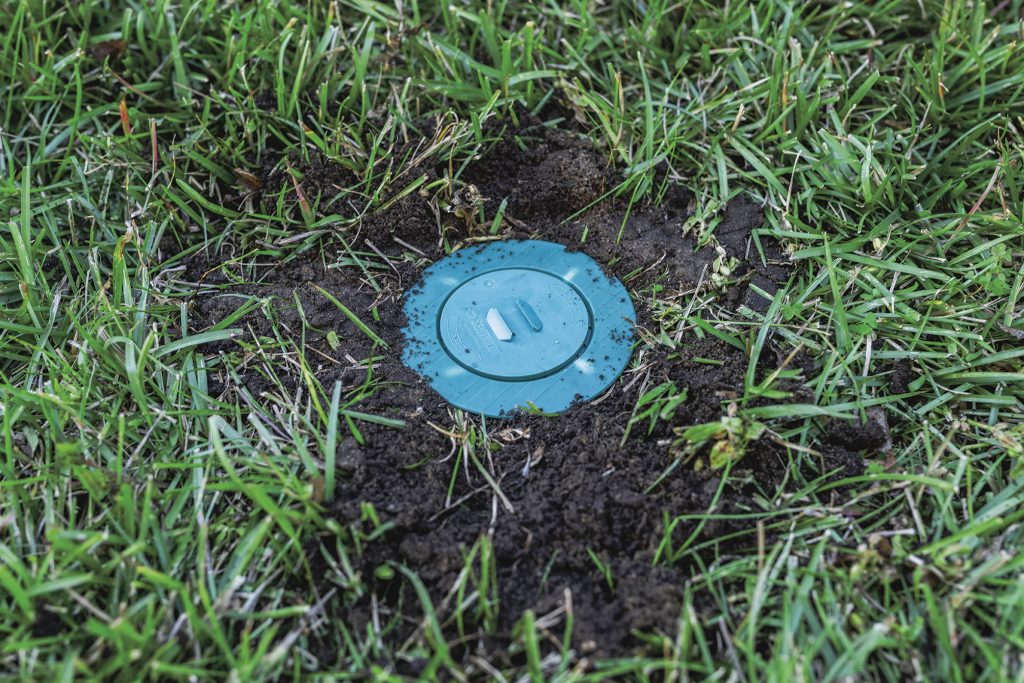 Sentricon® Termite bait station installed in a yard.